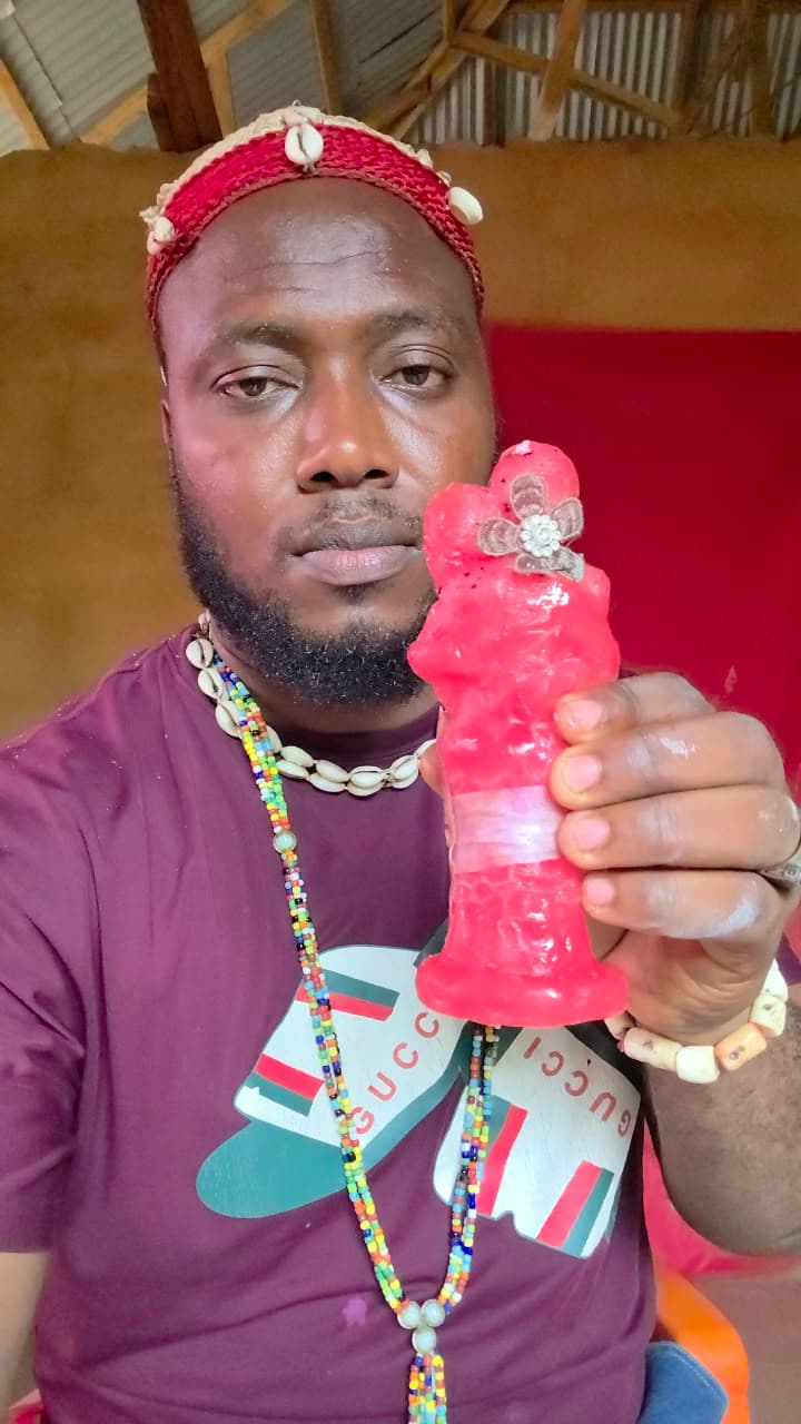 Dr. Iteh holding the red ITEH spiritual product