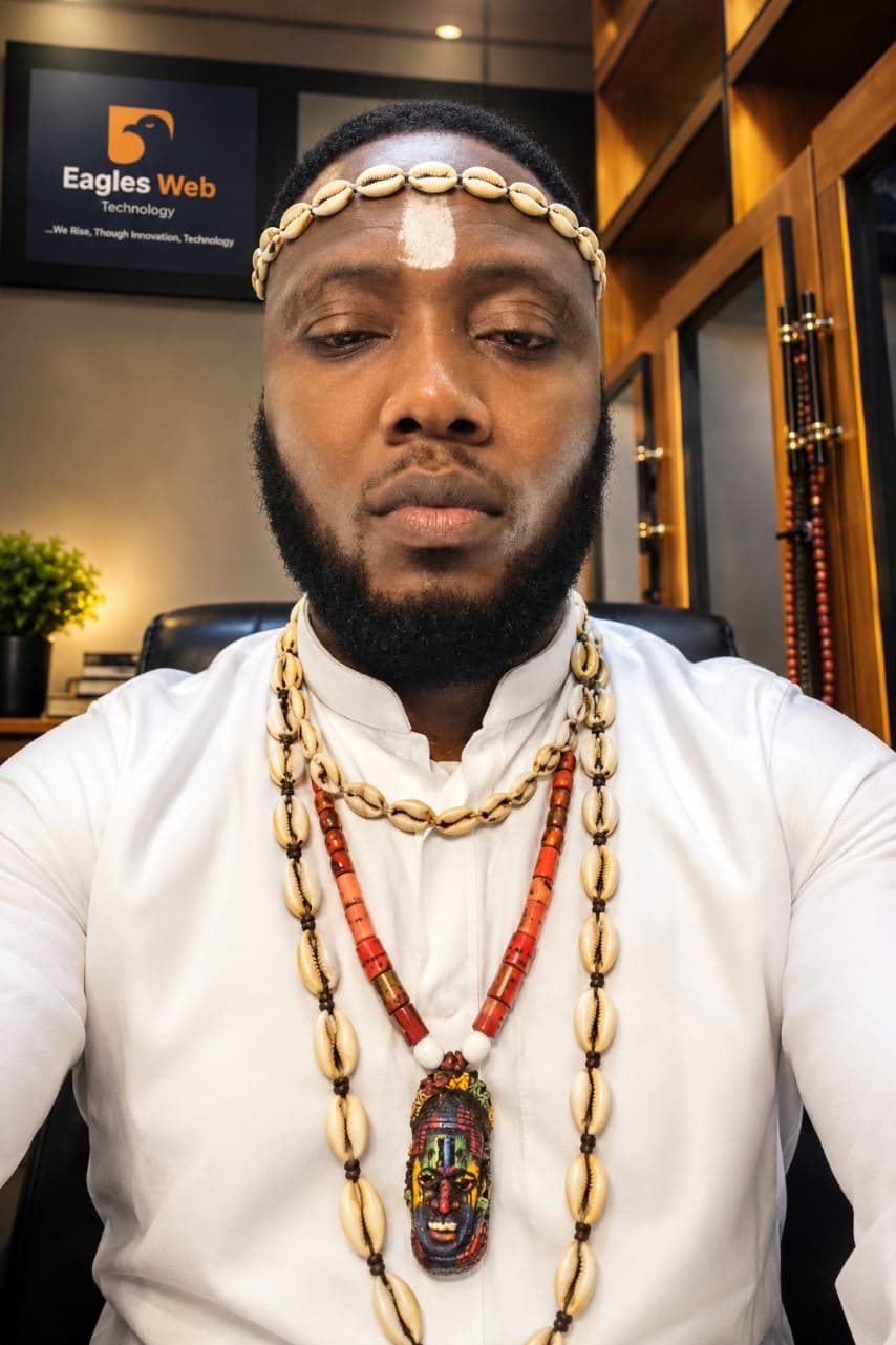 Dr. Iteh N Okpẹhoro wearing cowrie headband and necklaces